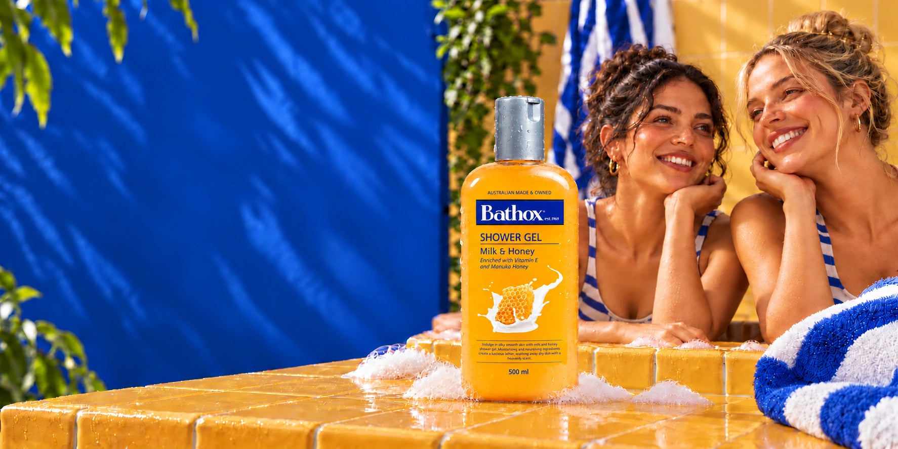 Bathox Milk & Honey with two smiling women and blue and yellow tiles.